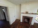 Vintage living room featuring a brick fireplace and hardwood floors at 1785 S Olympian Sw Way, Atlanta, GA 30310