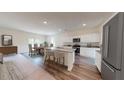 Open kitchen featuring stainless steel appliances, granite countertops, island with bar stool seating at 333 Torcello Blvd, Mcdonough, GA 30253