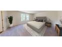 Spacious main bedroom with a large bed, neutral décor, plush carpet, and natural light from bright windows at 333 Torcello Blvd, Mcdonough, GA 30253