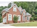 Brick home with attached garage and manicured lawn in a serene, wooded setting at 370 Beracah Sw Trl, Atlanta, GA 30331