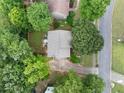An aerial perspective of a two-story home, landscaped yard, and tree lined neighborhood at 404 Pine Grove Way, Woodstock, GA 30189
