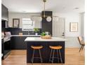 Modern kitchen with island, stylish lighting, quartz countertops, and stainless steel appliances at 124 Richmond Se St, Atlanta, GA 30312