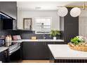 Sleek kitchen featuring modern appliances, dark cabinets and quartz countertops at 124 Richmond Se St, Atlanta, GA 30312