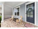 Cozy front porch featuring rocking chairs and a charming front door at 2075 Parkhaven Ct, Roswell, GA 30076