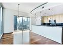 Modern kitchen features a breakfast bar, stainless steel appliances, and beautiful city views from the large windows at 361 17Th Nw St # 1702, Atlanta, GA 30363