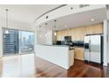 Modern kitchen boasts sleek cabinets, black countertops, and stainless steel appliances, all with a beautiful city view at 361 17Th Nw St # 1702, Atlanta, GA 30363
