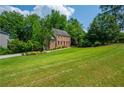 A landscaped yard leads to this two-story brick home with a striking red front door at 1885 N Creek Cir, Alpharetta, GA 30009
