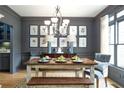 Elegant dining room features a rustic wood table with bench seating and stylish decor at 5963 Wild River Vw, Sugar Hill, GA 30518
