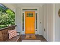 The bright orange front door adds a welcoming pop of color to the entry of this lovely home at 629 2Nd Avenue, Decatur, GA 30030