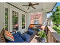 Cozy outdoor living space with comfortable seating and ceiling fan on a covered porch at 629 2Nd Avenue, Decatur, GA 30030