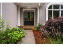 Inviting front entrance with double doors, stone steps, and vibrant landscaping at 1010 Longcreek Pointe, Alpharetta, GA 30005