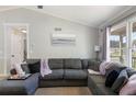 Bright living room showcasing a large sectional sofa and ample natural light at 379 Villa Rosa Way, Temple, GA 30179