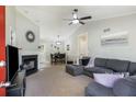 Inviting living room featuring a modern fireplace, vaulted ceilings, and a comfortable sectional sofa at 379 Villa Rosa Way, Temple, GA 30179