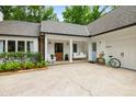 Inviting porch area with a swing, a bicycle, and manicured garden at 7114 Surrey Pt, Alpharetta, GA 30009