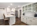 Modern white kitchen featuring stainless steel appliances, and a breakfast bar at 7114 Surrey Pt, Alpharetta, GA 30009