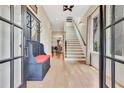 Inviting foyer with hardwood floors, coat rack, and staircase leading to the upper level at 210 4Th St, Fayetteville, GA 30214