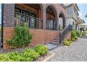 Beautifully landscaped front yard with stone walkway, brick stairs, and lush green bushes at 210 4Th St, Fayetteville, GA 30214