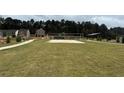 The community features a well maintained sand volleyball court with nearby homes and a path at 5370 Tolar Rd, South Fulton, GA 30213