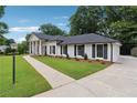 This lovely home has a sidewalk leading to the main entry and a manicured lawn at 5631 Queensborough Dr, Atlanta, GA 30338