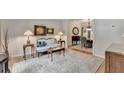 Cozy living room with hardwood floors, area rug, lamps, couch, and view of dining room at 785 Cirrus Dr, Johns Creek, GA 30022