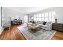 Bright living room featuring hardwood floors, neutral paint, large windows, and stylish furnishings at 956 Clifton Ne Rd, Atlanta, GA 30307