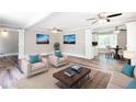 Bright living room with hardwood floors, white trim, and ceiling fans at 1916 Highway 138 Sw, Conyers, GA 30094