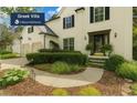 Beautiful white home featuring lush landscaping, a two-car garage and a welcoming front entrance at 3570 Bardfield Ct, Cumming, GA 30041