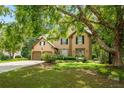 Charming two-story home featuring a well-manicured lawn and inviting entryway with lush landscaping and a two car garage at 3570 Bardfield Ct, Cumming, GA 30041