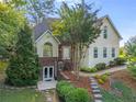 Charming two-story home featuring a lush landscaped front yard and inviting entryway at 5923 Rosie Se Ln, Mableton, GA 30126