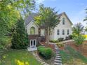 Charming two-story home featuring a lush landscaped front yard and inviting entryway at 5923 Rosie Se Ln, Mableton, GA 30126