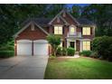 Traditional brick home with a manicured lawn and a two-car garage at 1115 Ballington Dr, Cumming, GA 30041