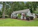 View of the home and landscaping with a well-kept lawn, bushes, trees and neutral-colored exterior paint at 2485 Hillside Ave, Decatur, GA 30032