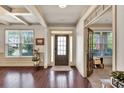 Elegant entryway with hardwood floors, decorative trim, natural light, and view of an office at 2525 Well Springs Dr, Buford, GA 30519