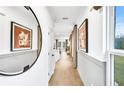 Bright hallway with modern decor, wood floors, and natural light, creating an inviting entryway at 5769 Tillman Way, Powder Springs, GA 30127