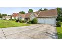View of the front exterior featuring a spacious driveway leading to a two-car attached garage at 99 Rainwater Ln, Dallas, GA 30157