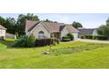 Ranch-style home featuring a well-kept lawn and mature landscaping with an attached garage at 99 Rainwater Ln, Dallas, GA 30157