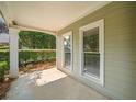 Inviting front porch with classic design, a supportive column, and picturesque views of the well-kept greenery at 1205 Compass Pointe Xing, Alpharetta, GA 30005