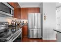 Modern kitchen showcasing stainless steel appliances, wood cabinets, and sleek countertops at 711 Cosmopolitan Ne Dr # 625, Atlanta, GA 30324