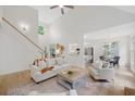 Bright living room featuring hardwood floors, a vaulted ceiling, and white walls, creating an open and inviting space at 112 Birchwood Pass, Canton, GA 30114