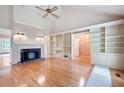 Spacious living room with hardwood floors, fireplace, built-in shelving, and vaulted ceilings at 170 Mayfield Cir, Alpharetta, GA 30009
