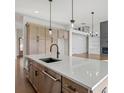 Modern kitchen with hardwood flooring, stainless steel appliances, and a large center island at 6520 Pond View Dr, Cumming, GA 30028