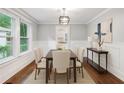 Formal dining area with natural light, wainscoting detail, and modern light fixture at 944 Deckner Sw Ave, Atlanta, GA 30310