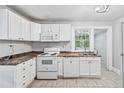 Well-lit kitchen with white cabinetry and appliances, providing a clean workspace at 944 Deckner Sw Ave, Atlanta, GA 30310