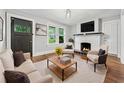 Inviting living room with a cozy fireplace, plush seating, and natural light at 944 Deckner Sw Ave, Atlanta, GA 30310