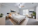 Modern main bedroom featuring neutral gray walls, carpet, ceiling fan, and a bright window view at 2173 Martin Way, Jonesboro, GA 30236