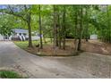 Wooded lot featuring a long drive leading to a beautiful house and separate storage shed at 3345 Bomar Rd, Douglasville, GA 30135