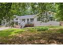 Beautiful two-story home featuring new exterior paint and a large front yard with mature trees at 3345 Bomar Rd, Douglasville, GA 30135