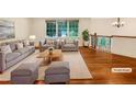Bright living room featuring hardwood floors, large windows, and comfortable staging at 2784 Williamsburg Way, Decatur, GA 30034