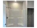 The bathroom features a glass-enclosed shower with white tile and a black shower head at 5381 Tolar Rd, South Fulton, GA 30213