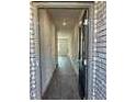 The foyer of the home has grey floors and white walls and leads to a main door at 5381 Tolar Rd, South Fulton, GA 30213